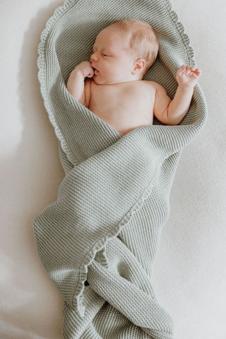 Newborn Baby wrapped in a Knitted Sage Green Baby Blanket